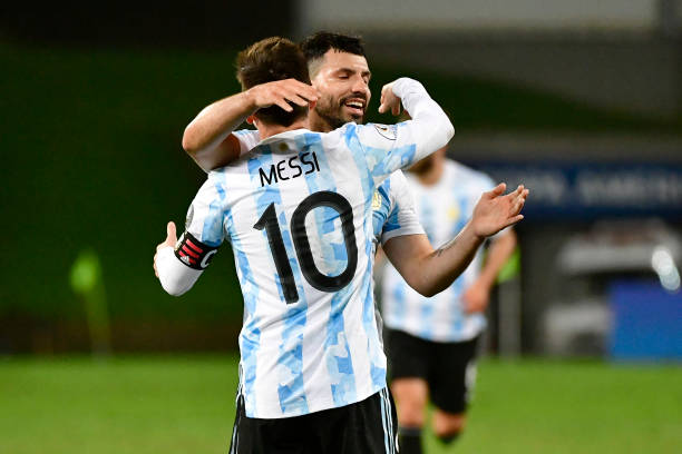 Lionel Messi of Argentina celebrates with teammate Sergio Agüero after scoring the third goal of his team during a Group A match between Argentina...