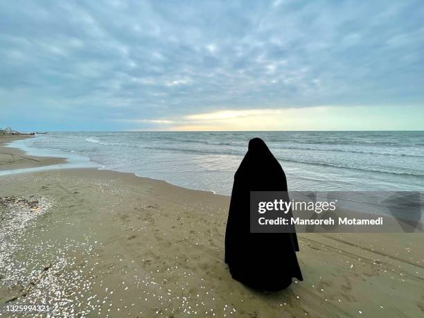 iranian muslim woman by the caspian sea - caspian sea stock pictures, royalty-free photos & images