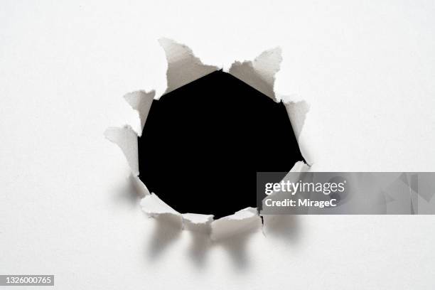 circle shape paper bullet hole - bullet holes stock pictures, royalty-free photos & images