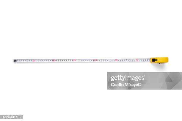 long tape measure isolated on white - liniaal stockfoto's en -beelden