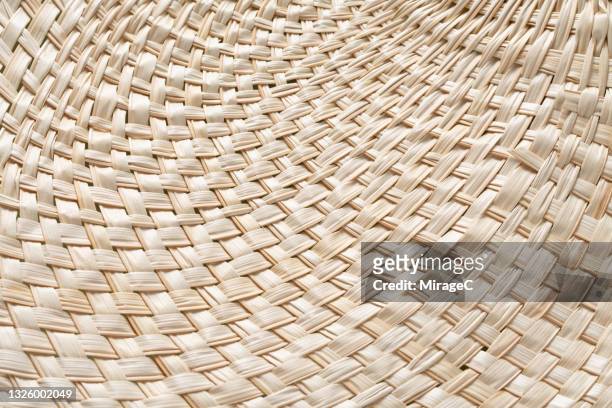 beige colored woven rattan fanned out pattern - 編んである ストックフォトと画像