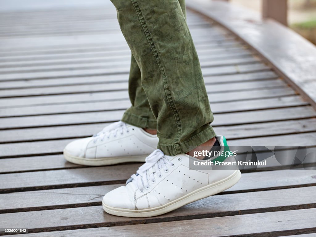 Model wearing brown cargo pants or cargo trousers with white sneakers