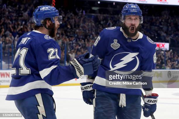 Nikita Kucherov of the Tampa Bay Lightning is congratulated by Brayden Point after scoring a goal against the Montreal Canadiens during the third...