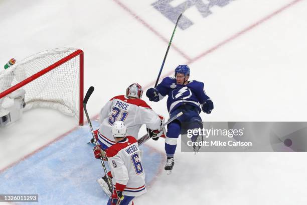 Ondrej Palat of the Tampa Bay Lightning gets tripped up against Carey Price of the Montreal Canadiens during the second period in Game One of the...