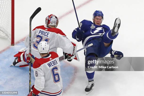 Ondrej Palat of the Tampa Bay Lightning gets tripped up against Carey Price of the Montreal Canadiens during the second period in Game One of the...