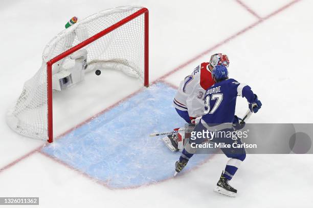 Yanni Gourde of the Tampa Bay Lightning scores a goal past Carey Price of the Montreal Canadiens during the second period in Game One of the 2021 NHL...