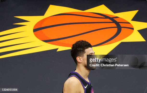 Dejected Devin Booker of the Phoenix Suns leaves the court following the team's loss to the LA Clippers during the second half in Game Five of the...