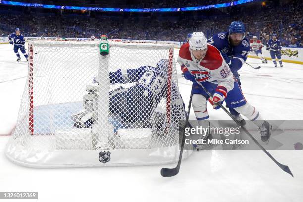 Artturi Lehkonen of the Montreal Canadiens is defended by Victor Hedman of the Tampa Bay Lightning as Andrei Vasilevskiy tends net during the third...