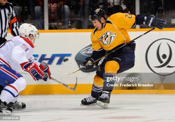 Raphael Diaz of the Montreal Canadiens skates against Jordin Tootoo of the Nashville Predators at the Bridgestone Arena on November 12, 2011 in...