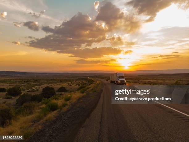 cargo transport long haul semi truck on a rural western usa interstate highway aerial photo series - truck smog stock pictures, royalty-free photos & images