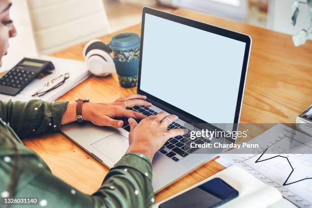 cropped shot of an unrecognizable businesswoman sitting alone in the office and using her laptop - www stock pictures, royalty-free photos & images