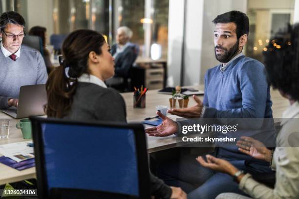 group of business colleagues talking on a meeting in the office. - gossip stockfoto's en -beelden