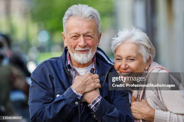 happy senior couple is spending a wonderful day together in city exploration. - endocrine system stock pictures, royalty-free photos & images