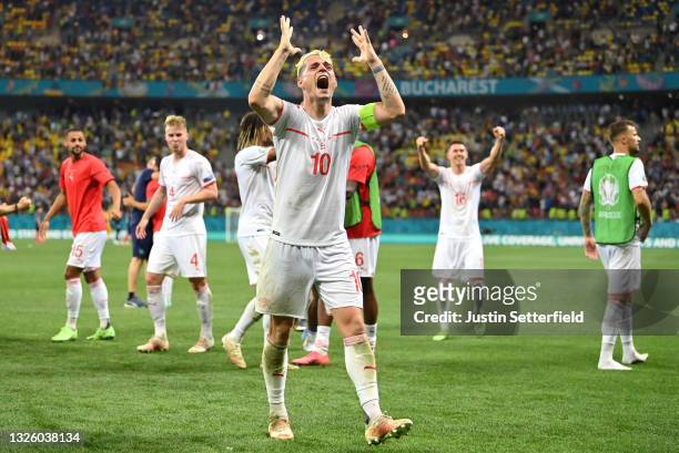Granit Xhaka of Switzerland celebrates their side's victory in the penalty shoot out after the UEFA Euro 2020 Championship Round of 16 match between...