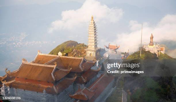 panoramic of kim son bao thang tu pagoda on misty sky, at the top of mount fanispan, sapa region, lao cai, vietnam - pagoda stock pictures, royalty-free photos & images