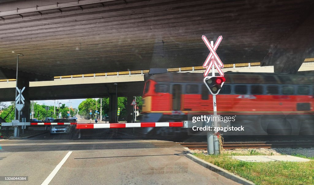 Railroad crossing with boom barrier and train