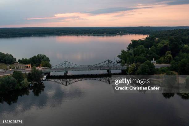 In this aerial view the Glienicke Bridge spanning the Havel river at sunset during the novel coronavirus pandemic on June 28, 2021 in Berlin,...