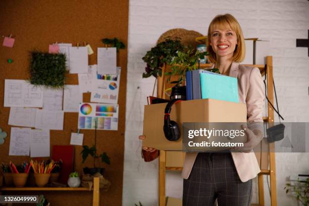 confident businesswoman walking into her new office - career change stockfoto's en -beelden