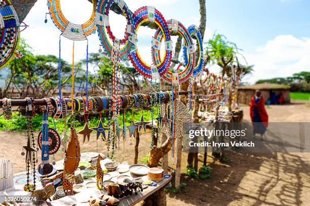 traditional maasai souvenir market in kenya or tanzania, in african savanna. - africa craft stock-fotos und bilder