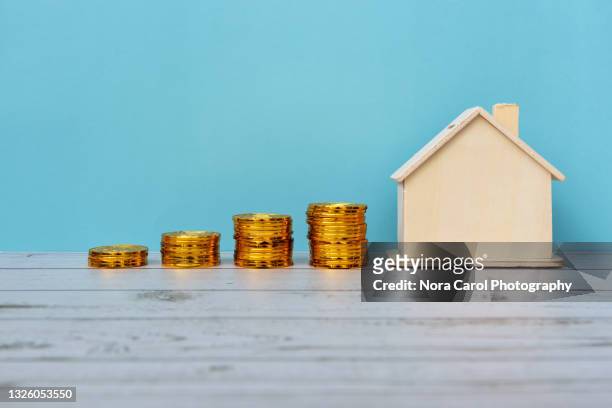 stacked of coins and house model - house price imagens e fotografias de stock