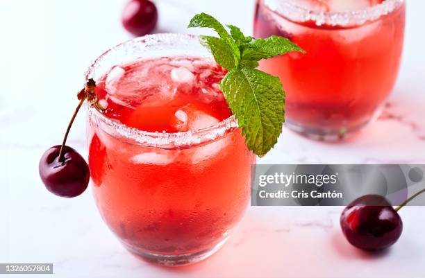 cherry cocktails on marble surface - cherry juice drink stock pictures, royalty-free photos & images