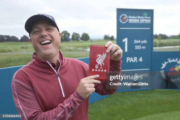 Graeme Storm of England poses with his beloved Liverpool FC yardage book ahead of the Dubai Duty Free Irish Open at Mount Juliet Golf Club on June...