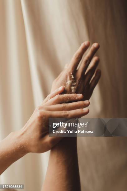 hand scrub treatment in the massage and spa salon - scrubbing stock pictures, royalty-free photos & images