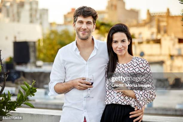 portrait of couple holding wineglasses on terrace - argentina wine stock pictures, royalty-free photos & images