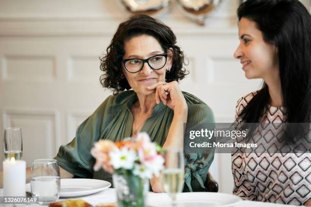 senior woman with daughter during birthday party - daughter birthday stock pictures, royalty-free photos & images