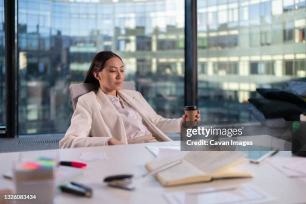 asian businesswoman resting in office - formal office stock pictures, royalty-free photos & images