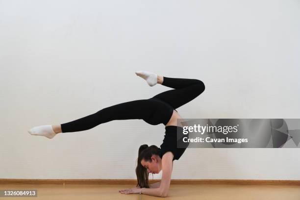 woman practicing handstand in gym - businesswoman handstand stock pictures, royalty-free photos & images