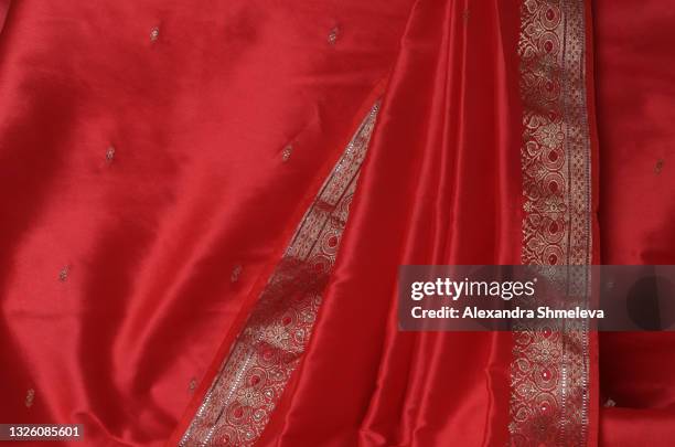 indian pink orange sari with a gold border close-up. - gold sari imagens e fotografias de stock