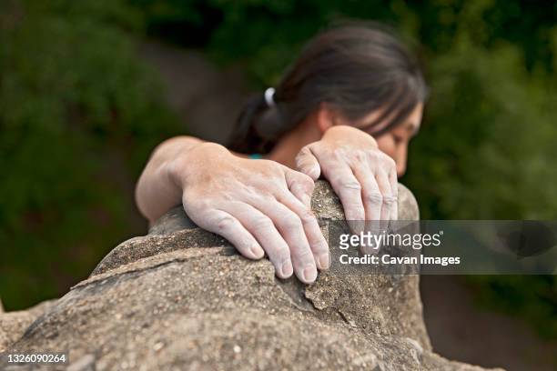 woman climbing on the sandstone rocks at harrison's rock in england - hand rock stock pictures, royalty-free photos & images