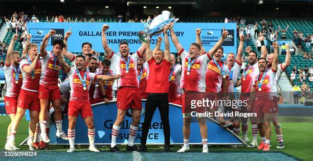 Stephan Lewies , Mike Brown and Alex Dombrandt of Harlequins raise the trophy after their victory during the Gallagher Premiership Final match...