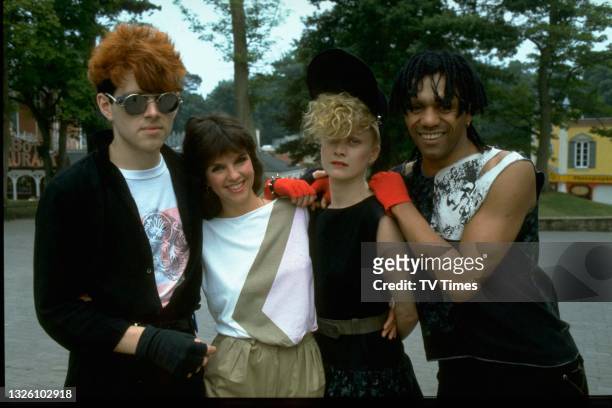 Television presenter Sue Robbie with British pop group Thompson Twins; Tom Bailey, Sue Robbie, Alannah Currie and Joe Leeway, circa 1983.