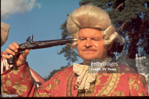Comedian and comic actor Benny Hill in character during a sketch on The Benny Hill Show, circa 1977.