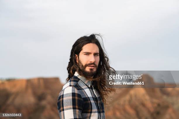 mid adult man with long hair - tousled hair man stock pictures, royalty-free photos & images