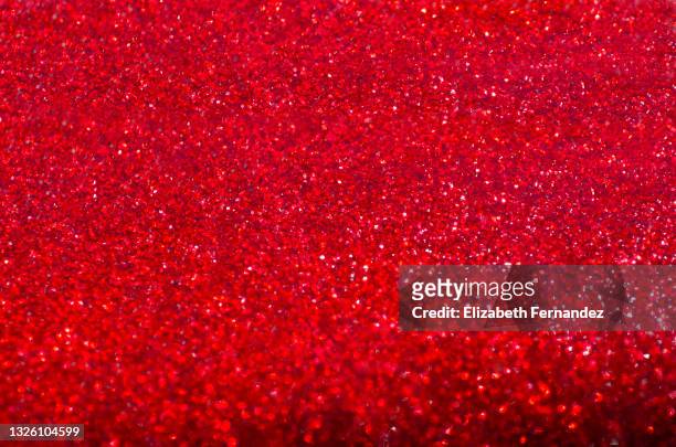 full frame of red glitter nail polish - red material stock-fotos und bilder