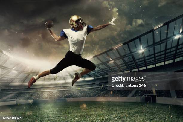 young man, professional american football player in motion, action during match at stadium. - quarterback stock pictures, royalty-free photos & images