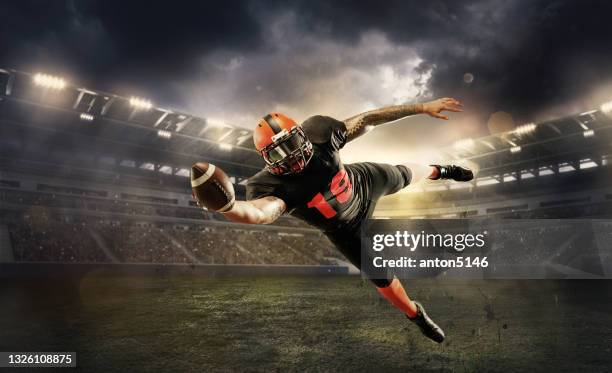 professional american football player in motion, action during match at stadium. - american football player silhouette stock pictures, royalty-free photos & images