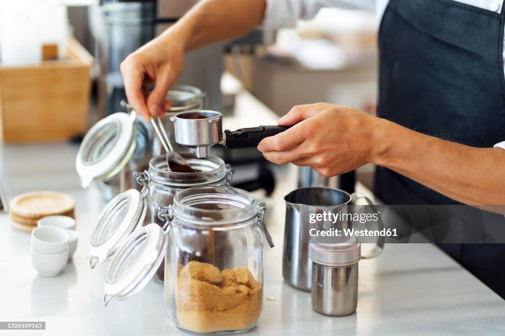 Chef preparing coffee in commercial kitchen