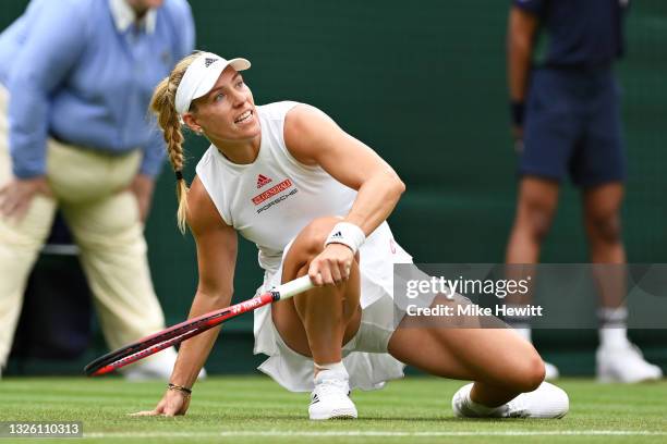Angelique Kerber of Germany slips in her Ladies' Singles First Round match against Nina Stojanovic of Serbia during Day Two of The Championships -...