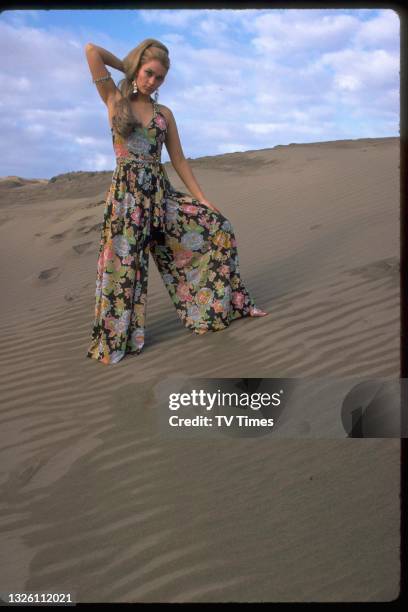 Actress Alexandra Bastedo modelling a floral trouser suit, circa 1969.