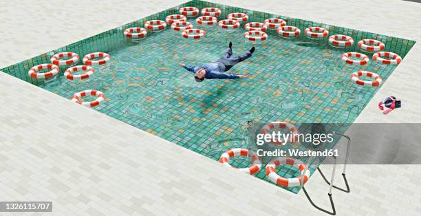 fully clothed office worker relaxing in swimming pool filled with life belts - life ring pool stock illustrations