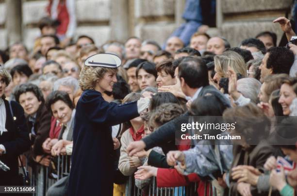 Diana, Princess of Wales greets the crowds in Milan, Italy, 21st April 1985. She is wearing a navy blue coat by Jan Van Velden and a navy and white...