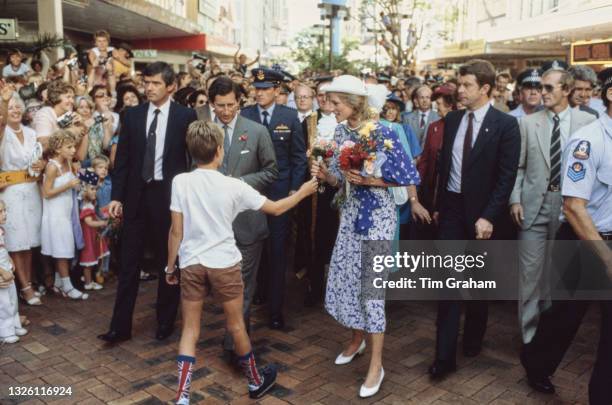 Prince Charles and Diana, Princess of Wales during a walkabout in Queen Street Mall, a shopping precinct in Brisbane, on their tour of Australia,...