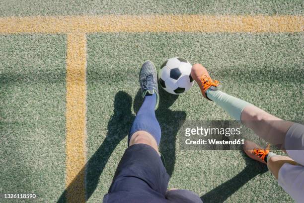 father and son playing soccer at sports court - looking down at feet stock pictures, royalty-free photos & images