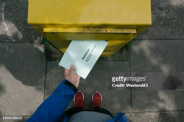 man putting ballot letter in mailbox - election stock pictures, royalty-free photos & images