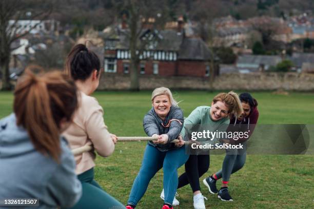 building strength and muscle - tug of war stock pictures, royalty-free photos & images