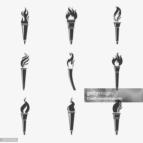 flaming torch silhouettes - torch flame icon stock illustrations